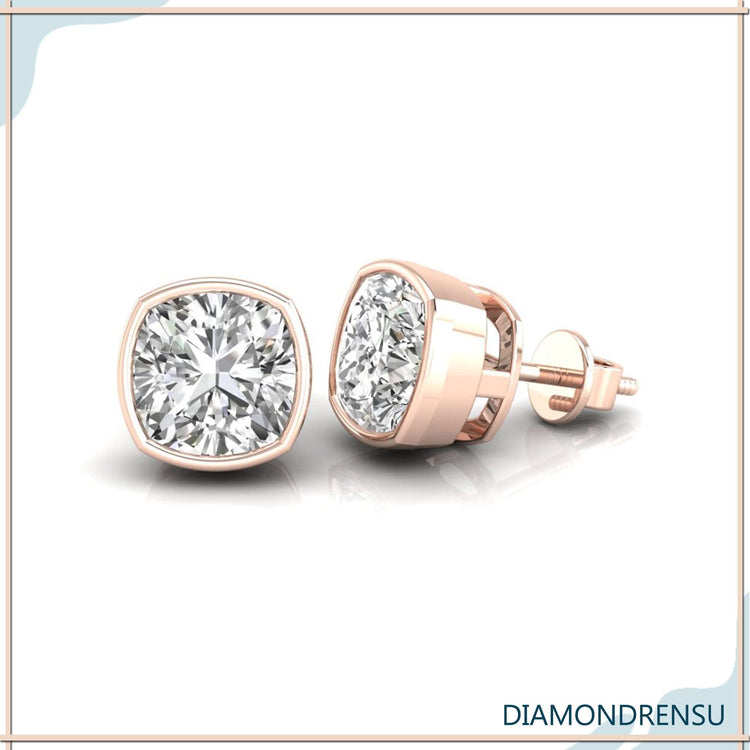 White gold diamond stud earrings featuring cushion cut stones.
