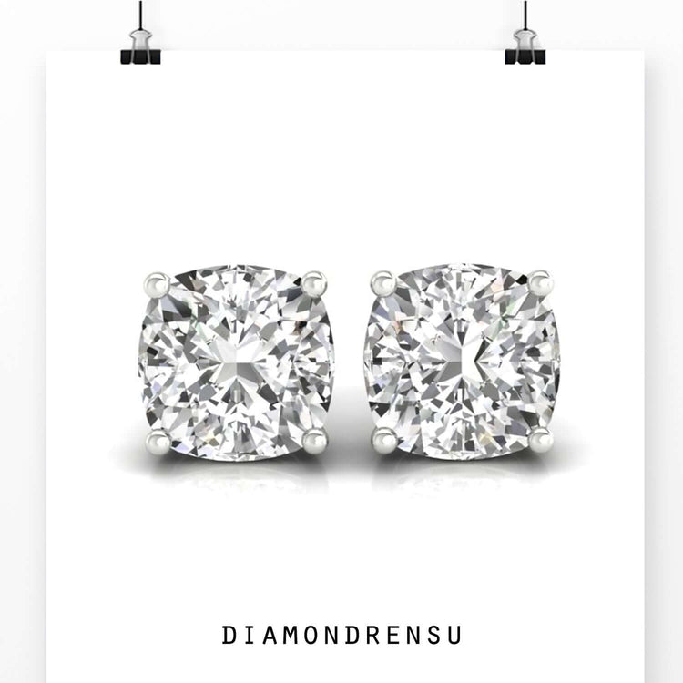 White gold cushion studs with four claw settings.
