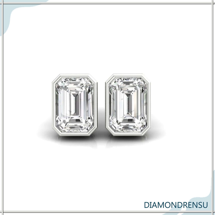 Lab grown diamond earrings with emerald step cut bezel setting.
