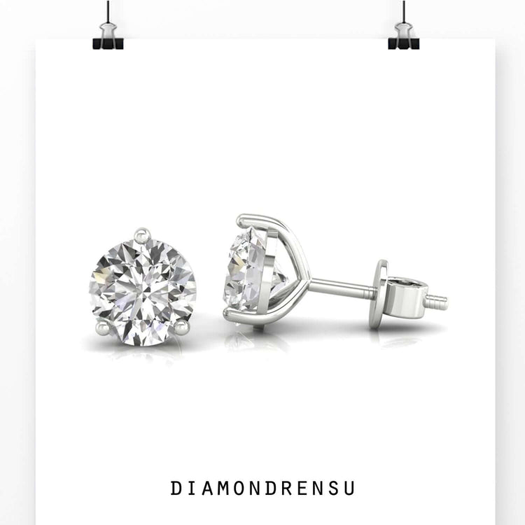 Gold stud earrings featuring round cut diamonds.
