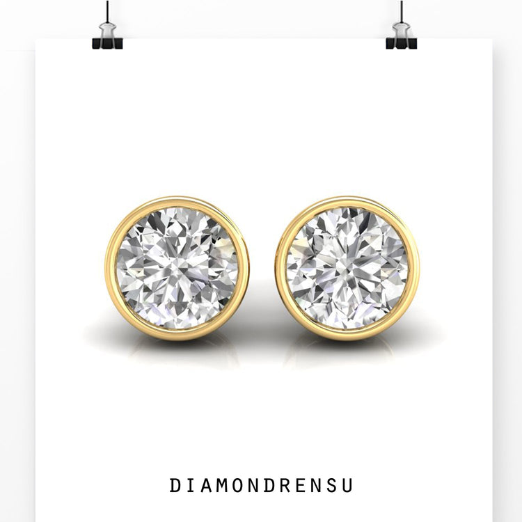 Rose gold diamond stud earrings with round cut stones.

