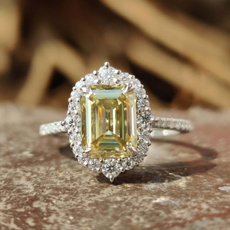 Canary yellow emerald cut moissanite ring in white gold.
