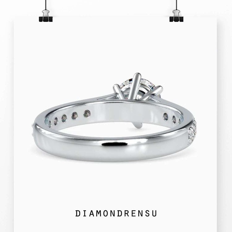 Rose gold ring with lab diamond and cathedral design.
