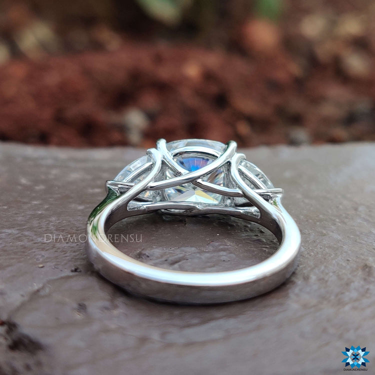 Cushion center stone ring with trillion cut side stones.
