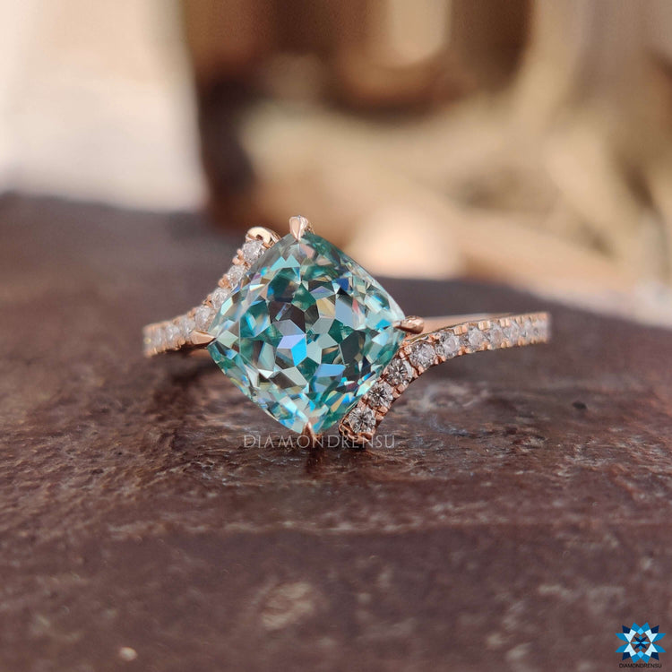 Bypass pave engagement ring with cushion Rensu cut moissanite.
