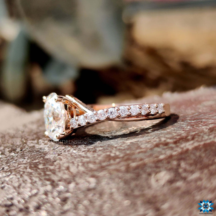 Oval cut moissanite ring with 4 round prong setting.
