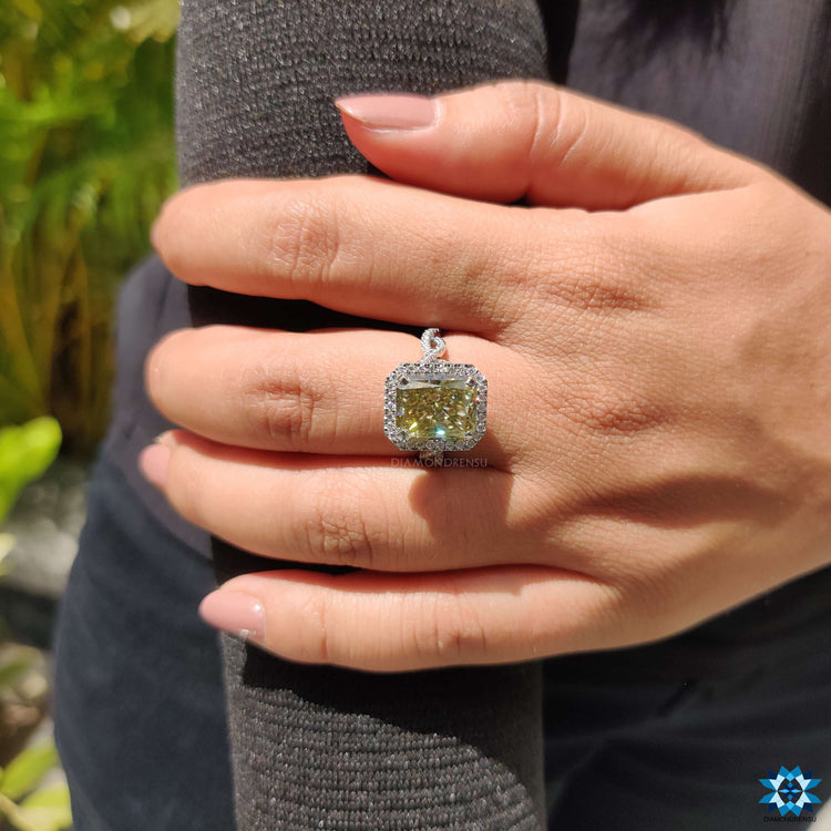 Twisted pave ring with radiant cut center moissanite.
