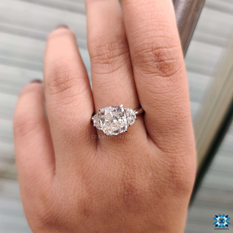 Cushion and half moon moissanite ring in cathedral mount.
