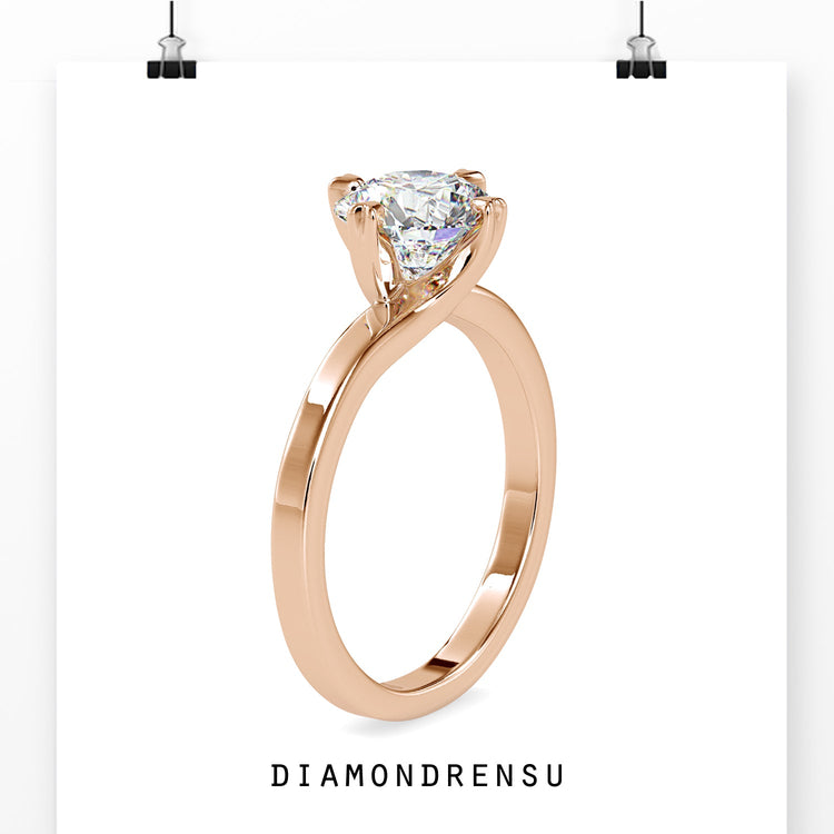 Simple diamond ring in yellow gold with heart prongs.
