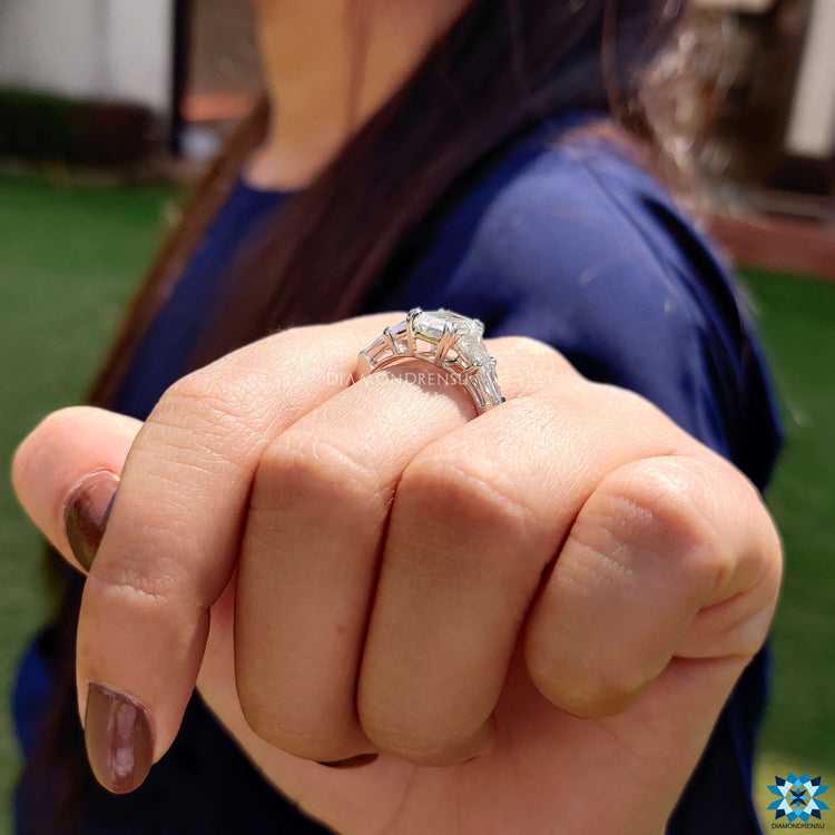 Moissanite engagement ring with two tapered side stones.
