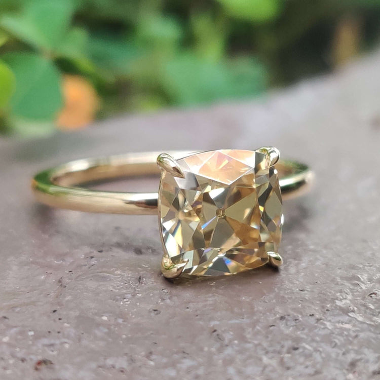 Old European cut moissanite ring in yellow gold.

