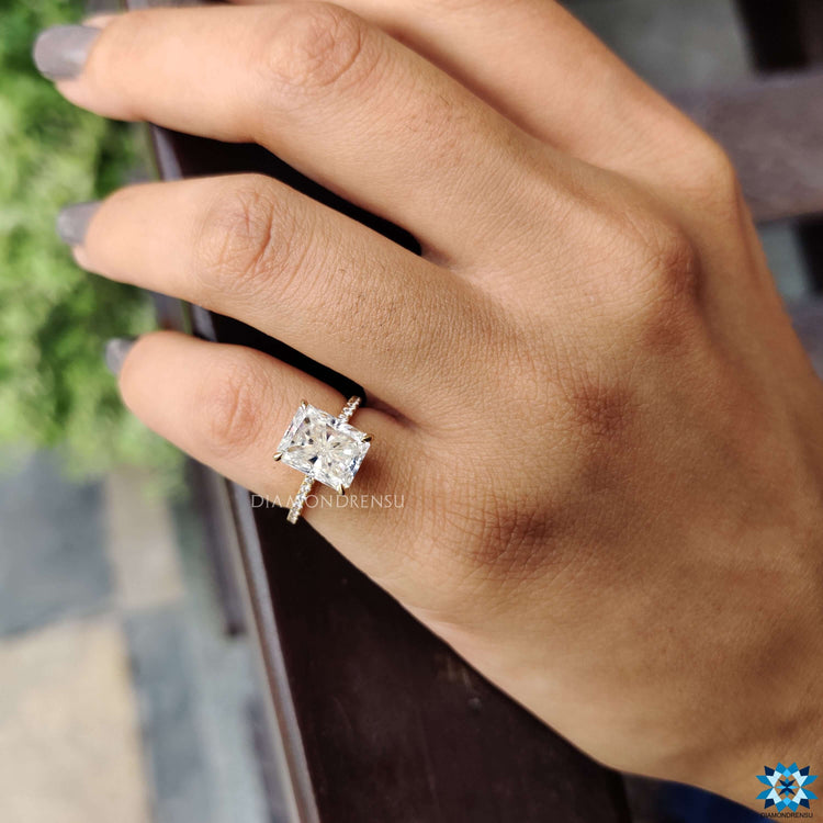 Yellow gold ring with radiant moissanite center.
