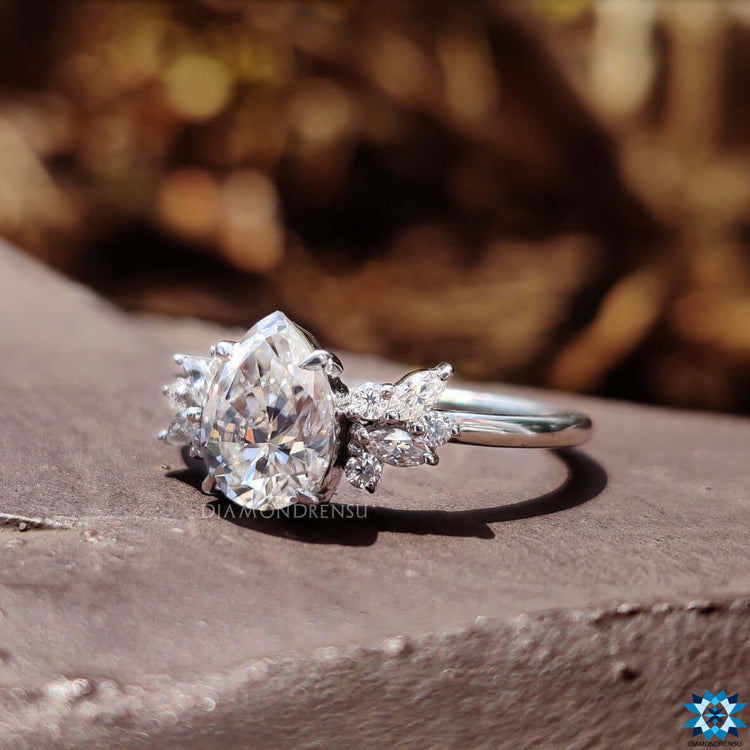 White gold ring featuring pear cut moissanite center.
