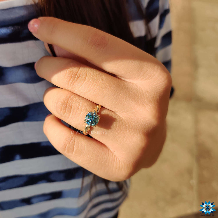 Round cut moissanite ring with hidden halo and twisted band.
