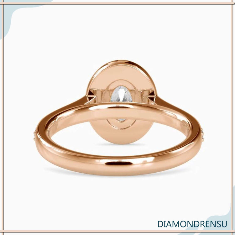 Lab grown diamond ring with round cut halo and prong setting.
