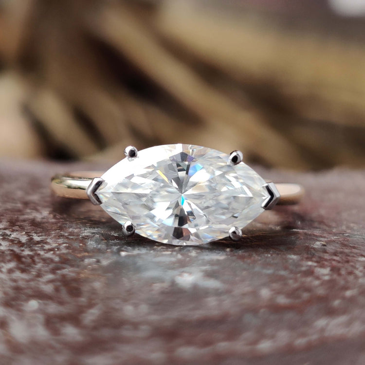 Marquise cut moissanite engagement ring with hidden halo.
