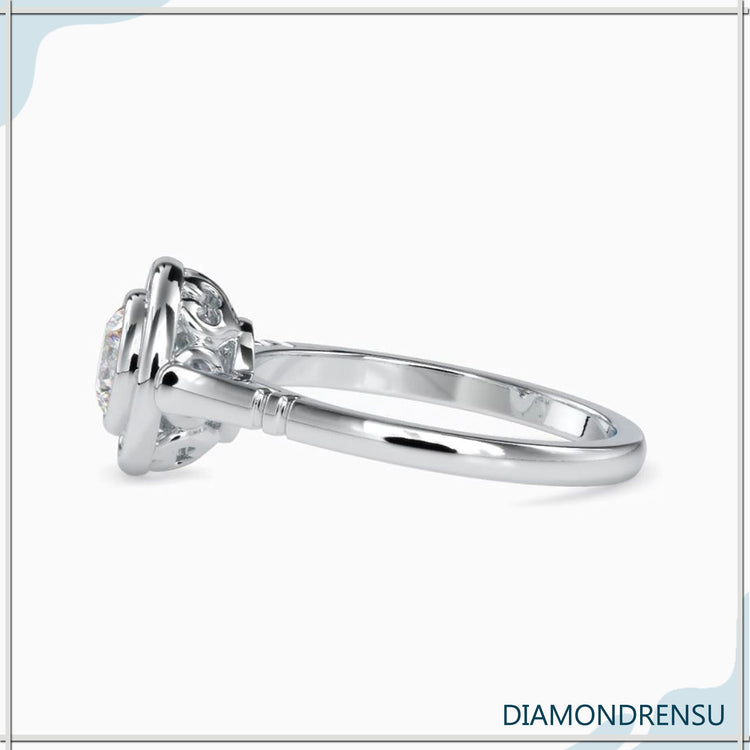 Yellow gold diamond ring with bezel solitaire design.
