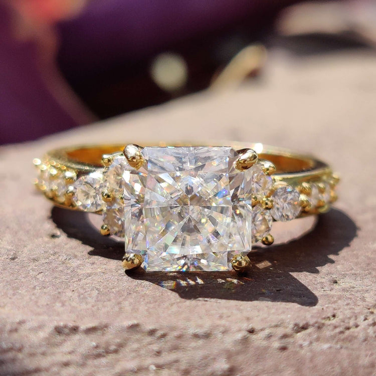 Square radiant cut moissanite engagement ring in yellow gold.

