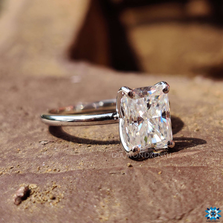 Custom engagement ring with radiant moissanite in prong style.

