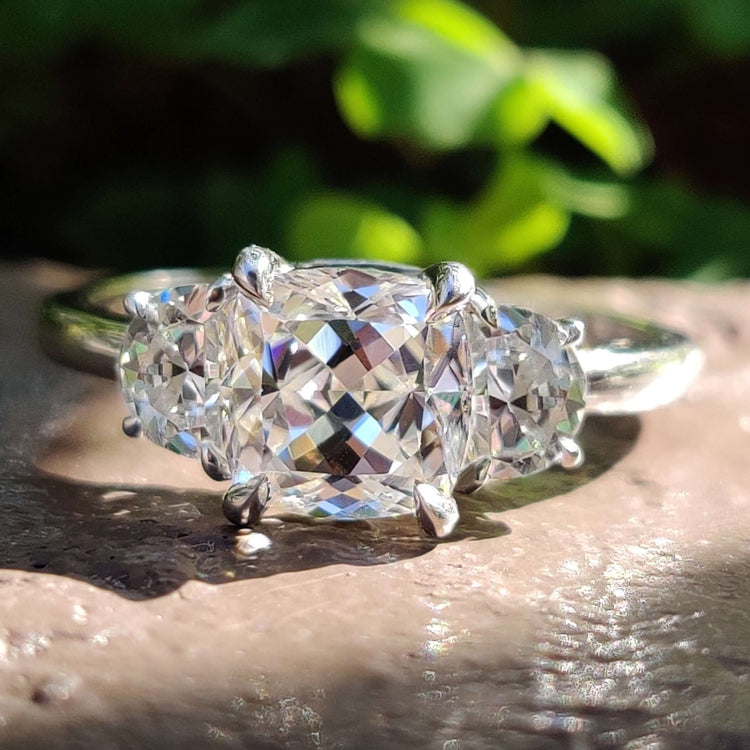 Three stone moissanite engagement ring in white gold.
