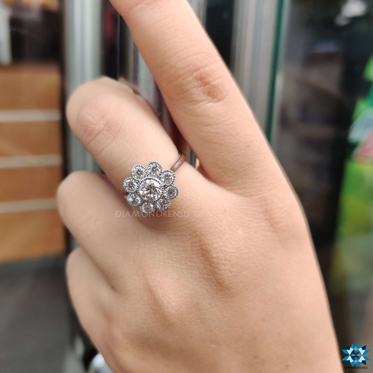 Engagement ring featuring round stones in a white gold bezel setting.
