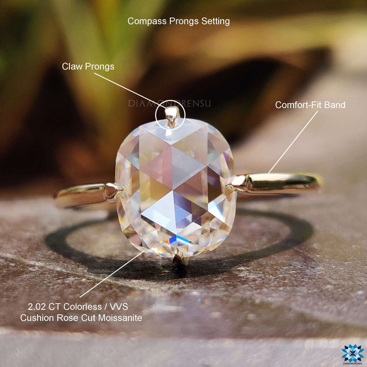 Yellow gold solitaire ring with cushion cut center.

