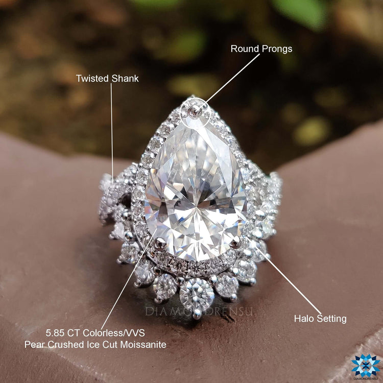 Prong setting ring with round cut moissanite side stones.
