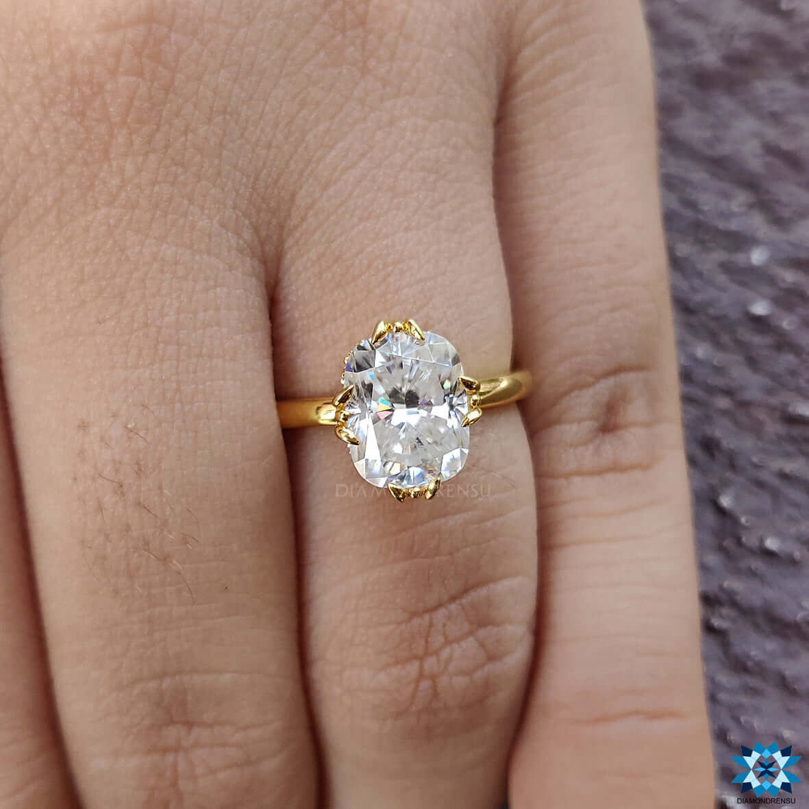 Handmade ring with an elongated cushion design and moissanite solitaire ring setting.