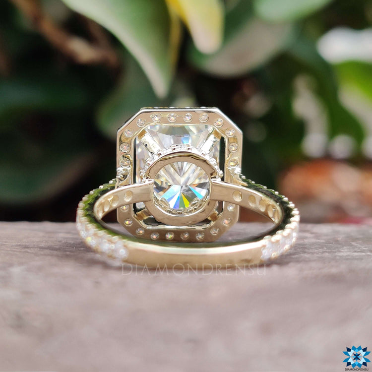 Custom yellow gold moissanite ring with pave band and halo design.
