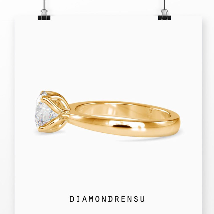 UK diamond ring with solitaire tulip style mount.
