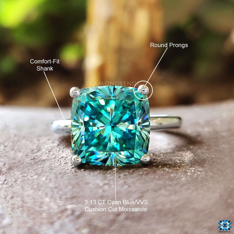 Handmade ring with cushion cut blue moissanite.
