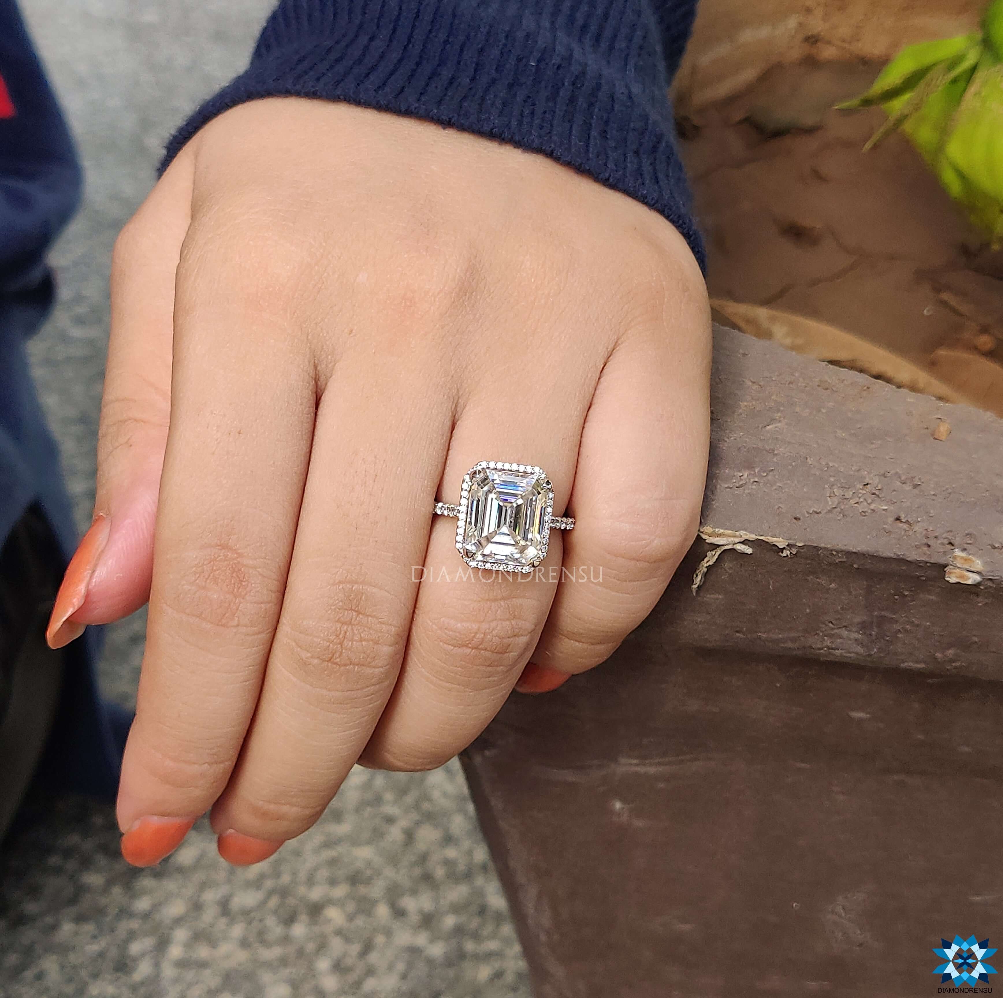 Emerald cut moissanite ring in a stunning emerald halo engagement ring setting.