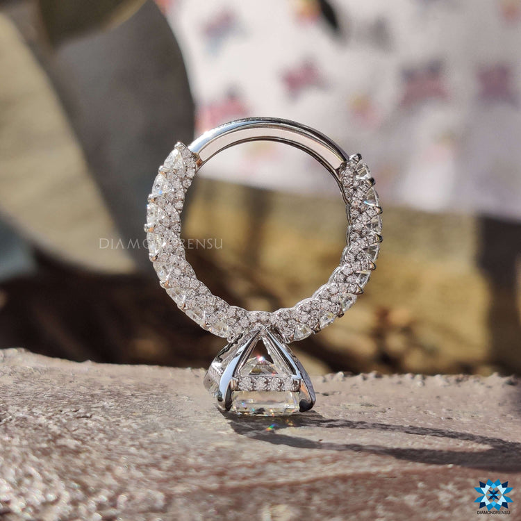 Round cut hidden halo set in white gold band.
