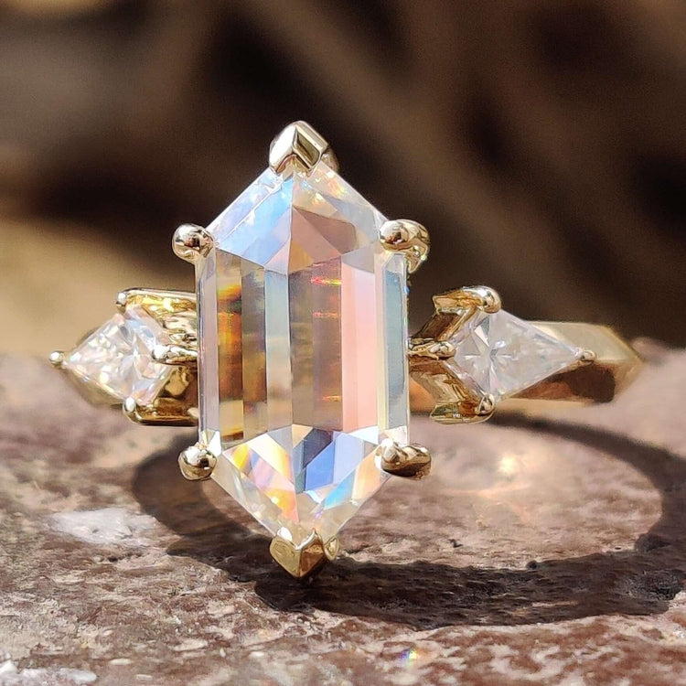 Three stone moissanite ring with hexagon center.
