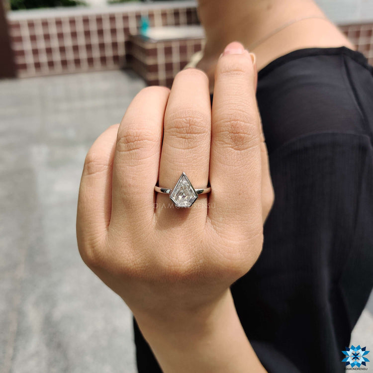 Bezel set engagement ring with moissanite solitaire.
