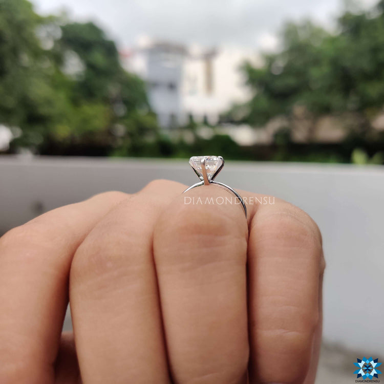 Radiant cut solitaire ring with four prong setting.

