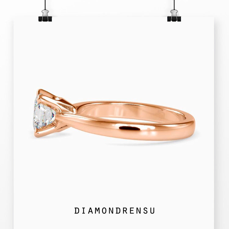 Simple diamond ring with solitaire princess cut and tab prong setting.
