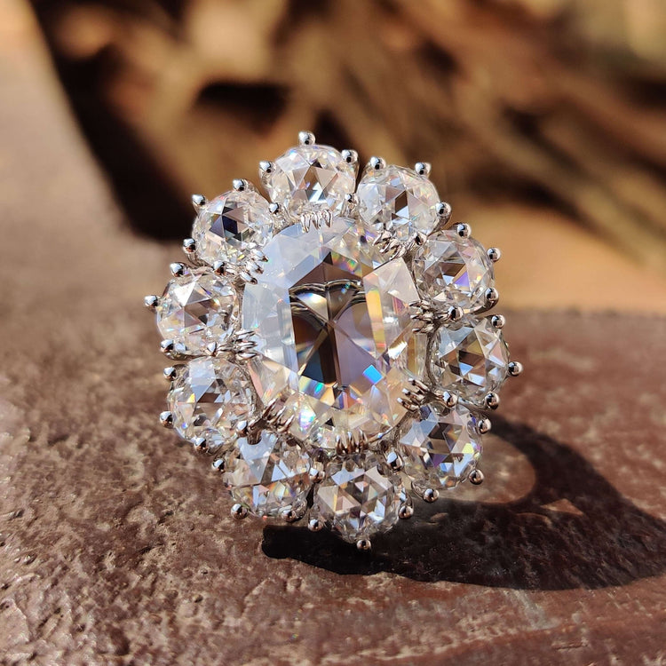 Rose cut engagement ring with oval centre stone in white gold.
