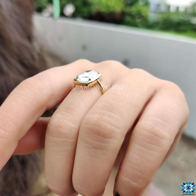 Elegant yellow gold engagement ring with moissanite center.
