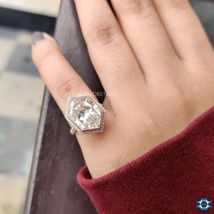 Elongated hexagon cut moissanite ring with custom setting.
