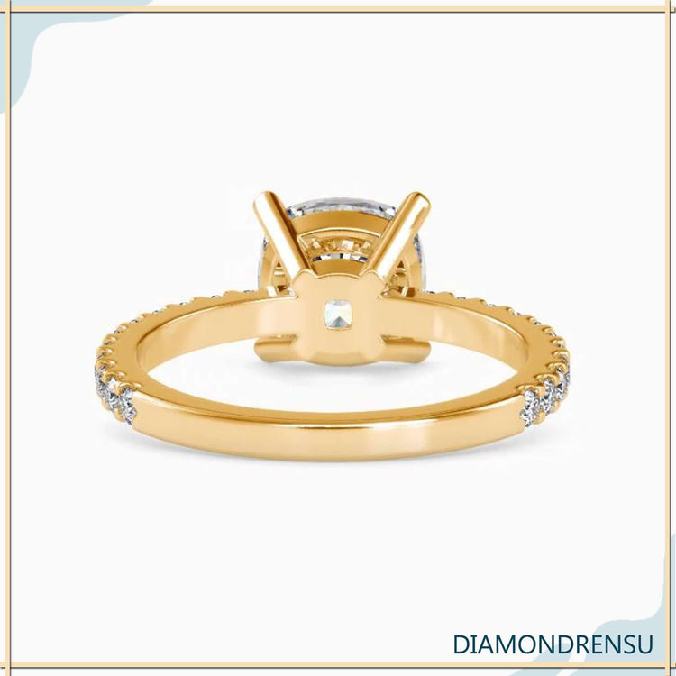 Cushion cut engagement ring with pave round cut band.
