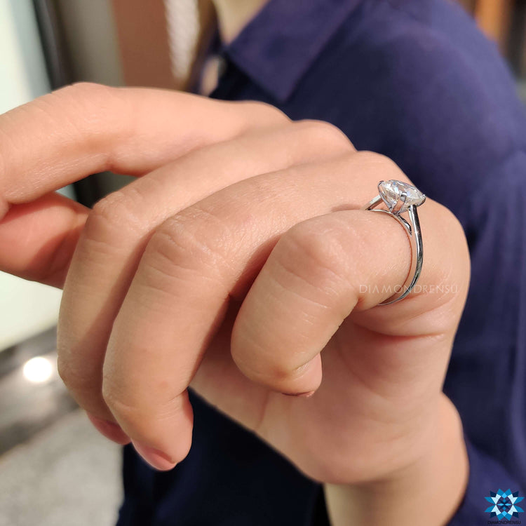 Simple round cut moissanite ring.
