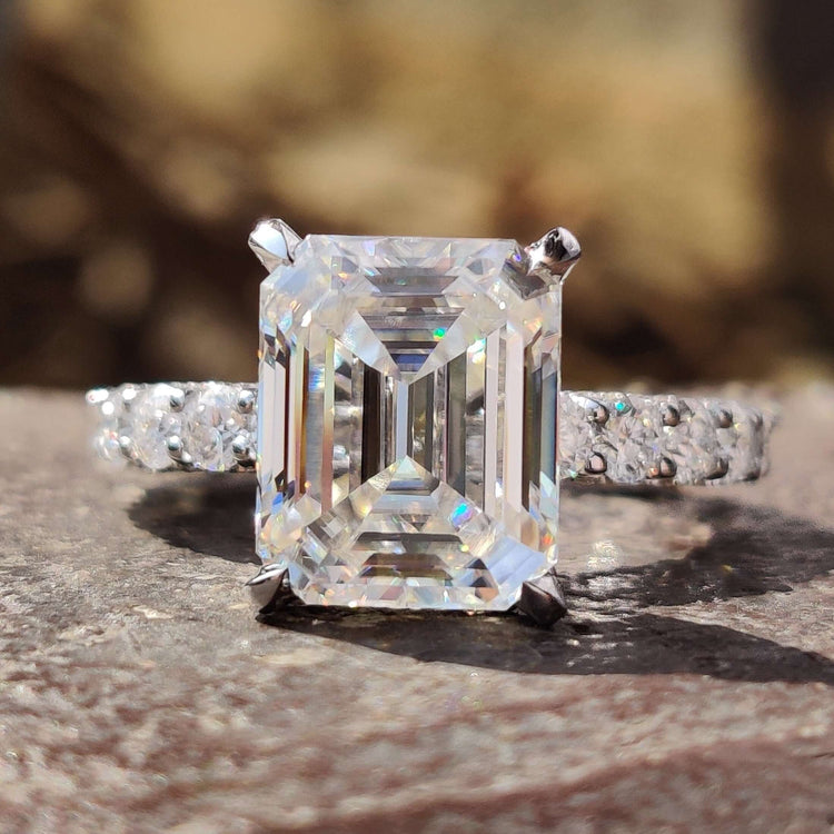 Emerald cut engagement ring with hidden halo design.
