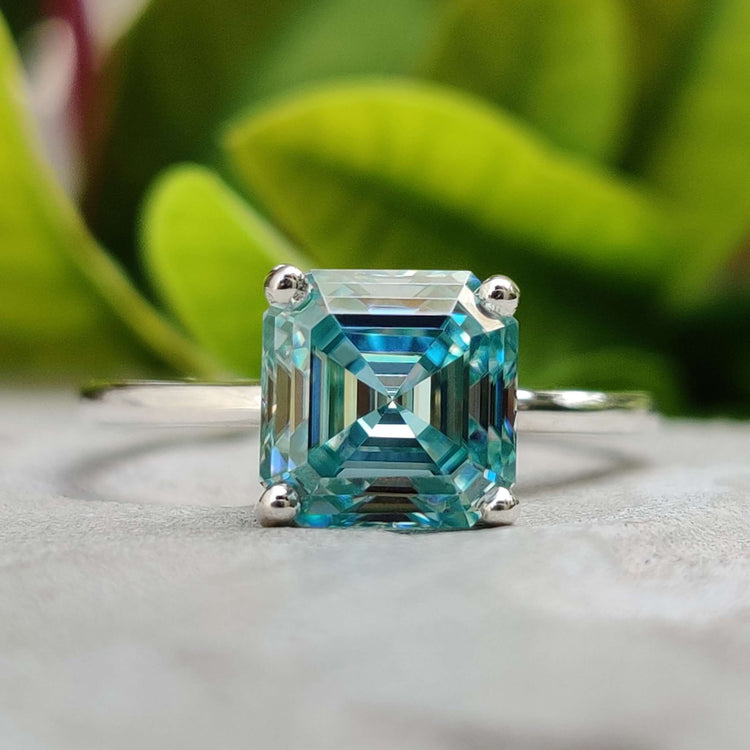 Asscher cut cyan blue moissanite engagement ring in white gold.

