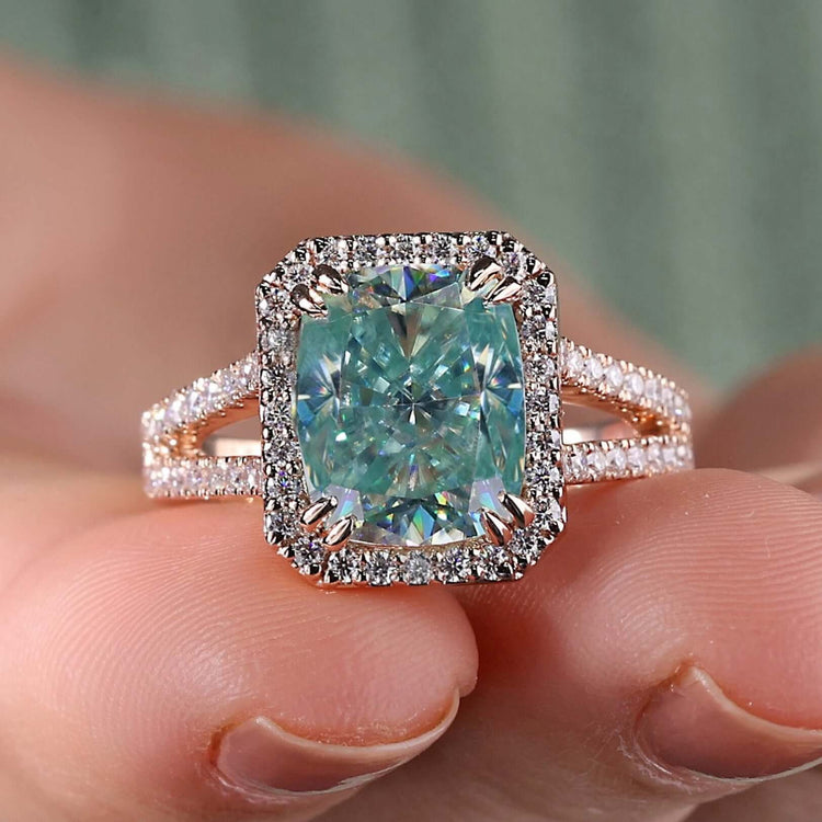 Light blue moissanite ring with cushion cut center.
