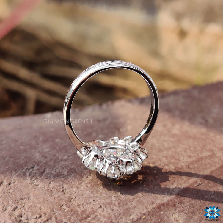 Cluster halo ring with round moissanite center.
