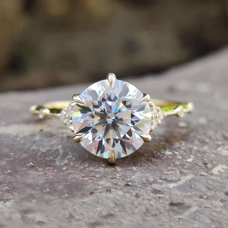 Vintage style moissanite engagement ring with round cut center.

