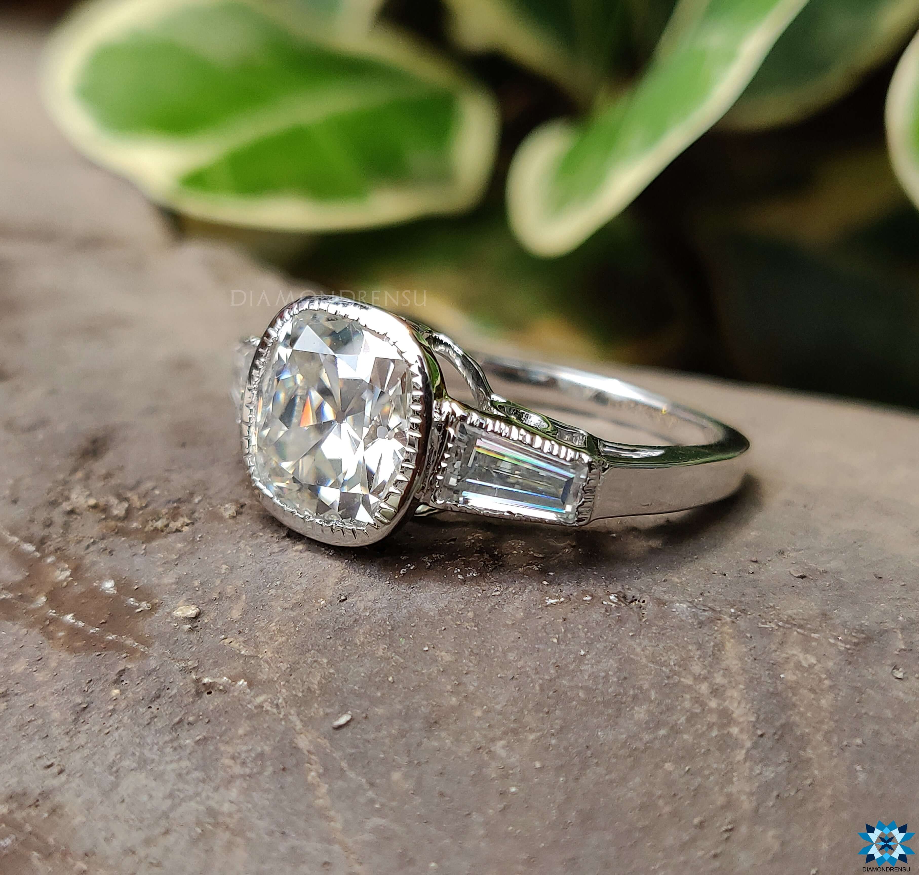 Tapered baguette ring with sparkling diamonds and a central moissanite stone.