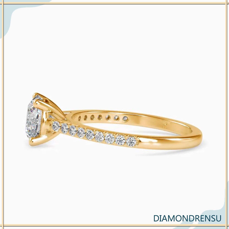 Round cut pave band engagement ring in yellow gold.
