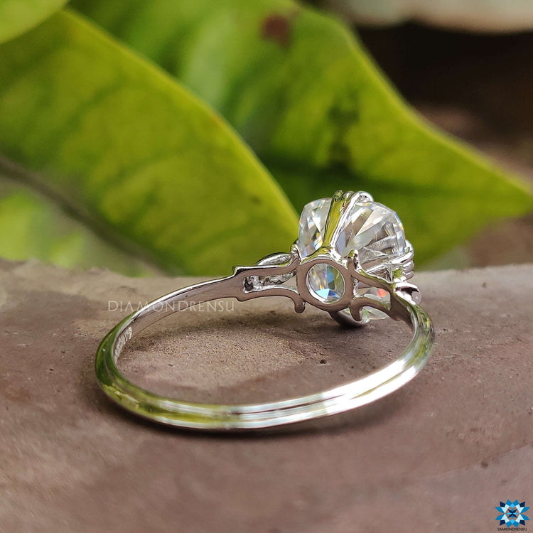 Prong set white gold ring with vintage cushion moissanite.
